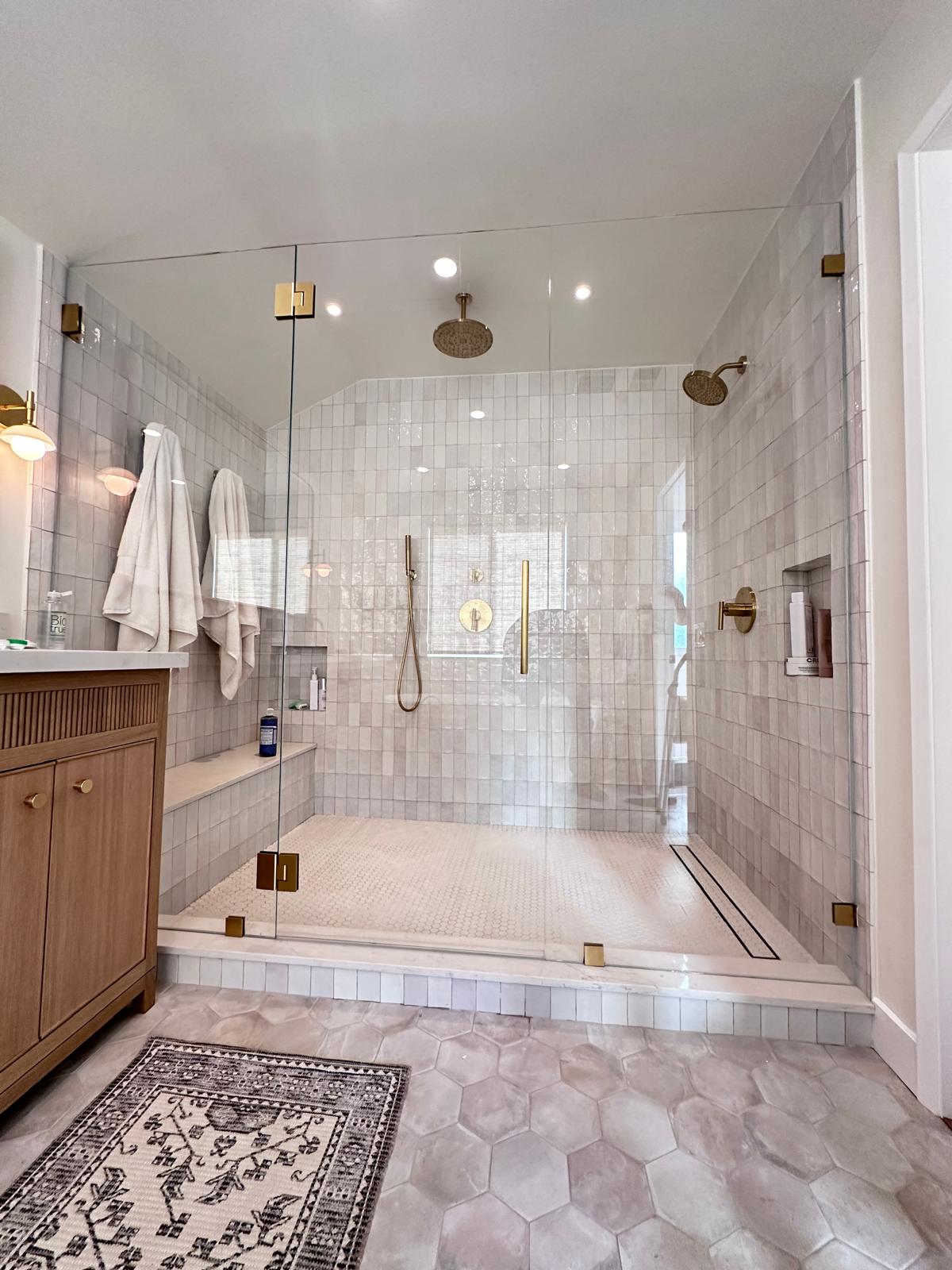 Walk-in shower remodel with handmade zellige tile, brushed gold fixtures and frameless glass